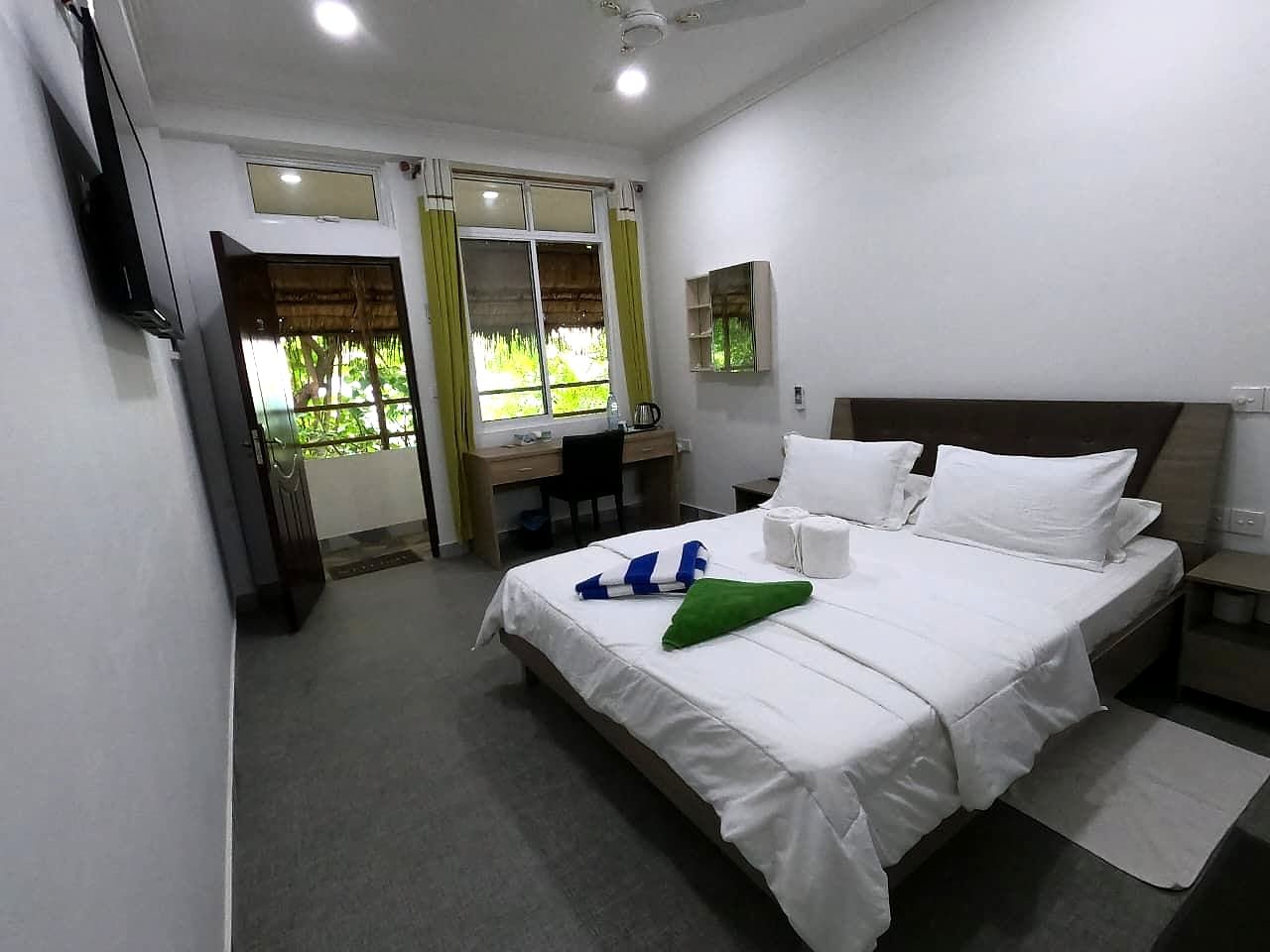 Deluxe Double room facing the window wall and balcony door
