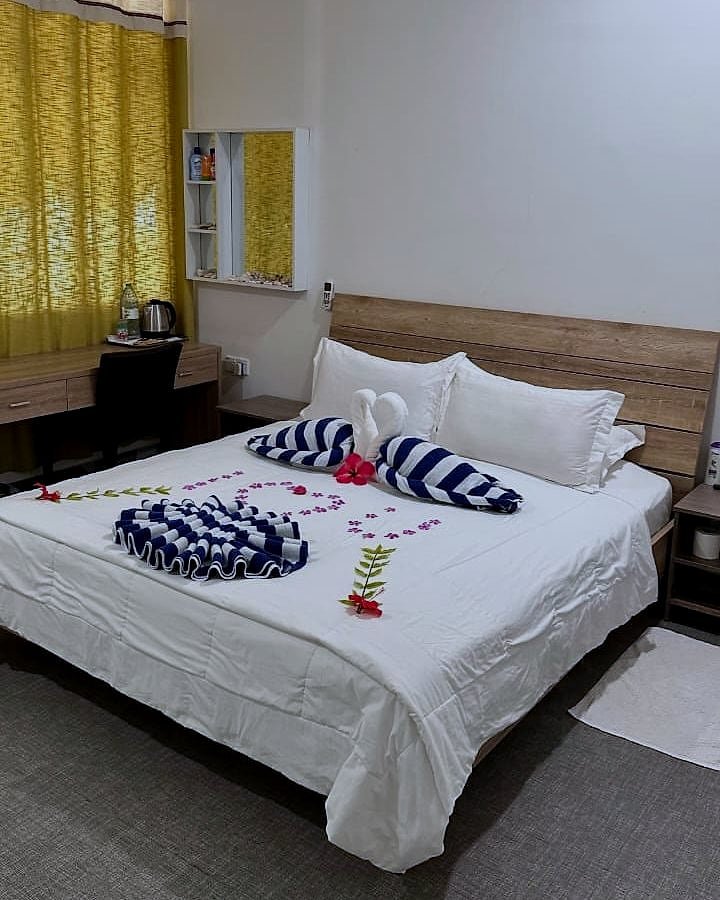 Family Room bed decorated with towel art and fresh petals